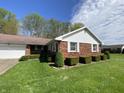 Well-maintained brick home with green lawn and manicured shrubbery at 89 Judy Dr, Martinsville, IN 46151
