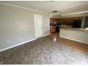 Open kitchen with wood cabinets, black appliances, and dining area with tile floor at 9048 E 36Th St, Indianapolis, IN 46235