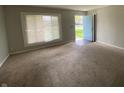 Bright living room with natural light streaming through the window and a view of the front door at 9048 E 36Th St, Indianapolis, IN 46235