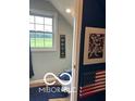 Small bathroom features a toilet, tile flooring, Americana decorations and a window with a view at 911 Centennial Rd, Martinsville, IN 46151