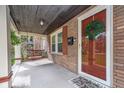 Inviting porch with a swing, wreath, and a 'Hello' welcome mat, creating a warm entry to the home at 914 Kessler Blvd E Dr, Indianapolis, IN 46220