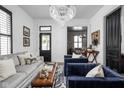 Bright living room featuring modern decor, stylish seating, chandelier, and an open floor plan at 946 Stillwell St, Indianapolis, IN 46202