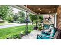 Inviting front porch with comfortable seating, string lights, and decorative iron columns at 1030 N Butler Ave, Indianapolis, IN 46219
