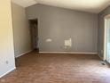 A blank canvas living room with wood floors, a sliding glass door, and freshly painted grey walls at 10569 Folsom Dr, Indianapolis, IN 46235