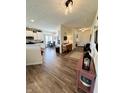 Open-concept living space with hardwood floors, modern lighting, and seamless flow to the dining and kitchen areas at 1119 E Main Cross St, Edinburgh, IN 46124