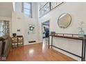 Bright and airy foyer with high ceilings, laminate floors, and a view of the staircase and adjacent living area at 11205 Echo Ridge Ln, Indianapolis, IN 46236