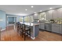 Open kitchen with a large island, barstool seating, and stainless steel appliances at 11469 Burkwood Dr, Carmel, IN 46033