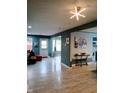Bright living room featuring modern lighting, stylish decor, and durable laminate floors at 11651 Congressional Ln, Indianapolis, IN 46235