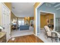 Open-concept living room with hardwood floors, blue accent walls, and neutral furnishings at 11697 Whisper Bay Ct, Carmel, IN 46033