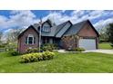 Charming single-Gathering home featuring a brick exterior, attached garage, and well-maintained lawn with mature landscaping at 12043 N Berling Dr, Mooresville, IN 46158