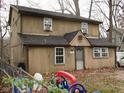 Charming two-story house featuring a front entrance, windows, and surrounding yard at 121 Lake Hart, Mooresville, IN 46158