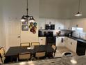 Bright kitchen features white cabinets, stainless steel appliances and dining area at 1316 Long Shore Dr, Indianapolis, IN 46217