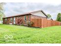Single story home with a fenced yard and a well-maintained lawn at 1355 Ash Ct, Martinsville, IN 46151