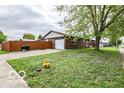 Ranch style home with an attached garage and a fenced yard on a sunny day at 1355 Ash Ct, Martinsville, IN 46151
