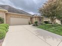 Beautiful brick home with an attached garage, wide driveway, and a well-kept lawn at 1395 Heron Ridge Blvd, Greenwood, IN 46143