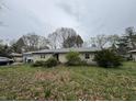 Single-story home featuring an attached garage and a well-treed lot at 1532 Greer Dell Rd, Indianapolis, IN 46260