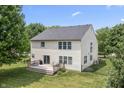 Aerial view of backyard with a wooden deck, grill, green lawn, privacy fence, and mature trees at 15936 Symphony Blvd, Noblesville, IN 46060