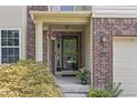 Charming front entryway with a decorative door, brick accents, lush greenery, and a well-maintained lawn at 15936 Symphony Blvd, Noblesville, IN 46060
