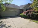 Charming brick home featuring an attached garage and lush landscaping at 1605 Fox Dr, Martinsville, IN 46151