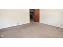 Neutral-toned bedroom with carpet flooring and an open doorway to an adjacent room at 2220 Radcliffe Ave, Indianapolis, IN 46227