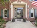 Inviting front entrance features a black front door, sidelight windows, and tasteful landscaping at 3601 Lakeshore Ct, Greenwood, IN 46143