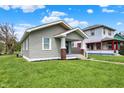 Charming home with a gray exterior, covered front porch, and well-maintained lawn, creating a welcoming curb appeal at 364 Congress Ave, Indianapolis, IN 46208