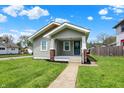 Charming home with a gray exterior, covered front porch, and well-maintained lawn, creating a welcoming curb appeal at 364 Congress Ave, Indianapolis, IN 46208