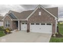 Attractive single-story home with brick facade, complemented by a well-kept lawn and a spacious two-car garage at 3697 Chalmers Dr, Bargersville, IN 46106