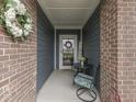Cozy front porch with stylish seating, wreath, and brick accents, creating an inviting entryway at 3697 Chalmers Dr, Bargersville, IN 46106