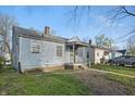 A single story home with peeling siding, offering an opportunity for renovation or investment at 3706 Baltimore Ave, Indianapolis, IN 46218