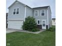 Charming two-story home with light gray siding, a white garage door, and manicured lawn at 4070 Presidio Cir, Indianapolis, IN 46235