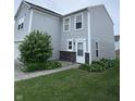 Charming two-story home with light gray siding, a white front door, and manicured lawn at 4070 Presidio Cir, Indianapolis, IN 46235