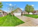Beautiful single-story home features a well-manicured lawn and a two-car attached garage at 4809 Ozark Ln, Indianapolis, IN 46239