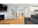 Open-concept living space showcasing fireplace, staircase, and seamless flow into other living areas at 4844 Morenci Ct, New Palestine, IN 46163