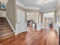 Spacious foyer showcasing hardwood floors, staircase, and access to an office or study at 4857 Silverbell Dr, Plainfield, IN 46168