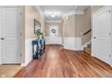 Bright foyer with hardwood floors, decorative molding, and a stylish entryway table at 4857 Silverbell Dr, Plainfield, IN 46168
