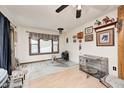 Bright living room featuring tile flooring, a large window for natural light, and a ceiling fan at 5320 S Lick Crk Rd, Morgantown, IN 46160