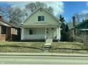 Welcoming home featuring a classic front porch with white columns and railings, complemented by a neat lawn and a clear sky at 537 N Rural St, Indianapolis, IN 46201