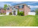 Beautifully landscaped brick home with a lush green lawn and mature trees at 5422 Portman Dr, Noblesville, IN 46062