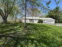 Charming ranch-style home featuring a well-maintained lawn and accessible ramp at 5822 W 62Nd St, Indianapolis, IN 46278