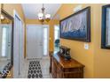 Bright foyer with tile flooring, white door, and an elegant wooden console table at 5982 Blue Heron Way, Plainfield, IN 46168