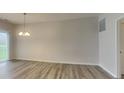 Open dining area with sliding glass door to yard and modern chandelier at 6118 Aspen Meadow Dr, Indianapolis, IN 46237