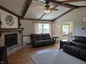 Cozy living room featuring a brick fireplace, beamed ceilings, and ample seating at 628 Williams Ct, Greenwood, IN 46142