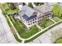 Beautiful aerial view of a home showcasing its manicured lawn and outdoor living space with patio set at 6655 Westminster Dr, Zionsville, IN 46077