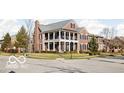 Handsome brick house with a double-decker porch in a desirable neighborhood setting at 6655 Westminster Dr, Zionsville, IN 46077