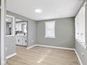 Open-concept living room with neutral walls, laminate flooring, and abundant natural light from the windows at 733 S Holmes Ave, Indianapolis, IN 46221