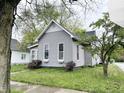 This gray house is situated on a grassy lot with mature trees, offering a peaceful and private setting at 741 Walnut St, Franklin, IN 46131