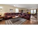 Spacious living room featuring a large leather sectional, fireplace and hardwood floors at 8211 Firefly Way, Indianapolis, IN 46259