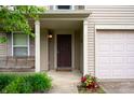 Inviting front porch with a porch swing and flower planter enhancing the home's curb appeal at 8211 Firefly Way, Indianapolis, IN 46259
