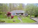 Beautiful home with landscaped front yard, mature trees, and unique wooden bridge walkway at 8329 S Christian Dr, Nineveh, IN 46164